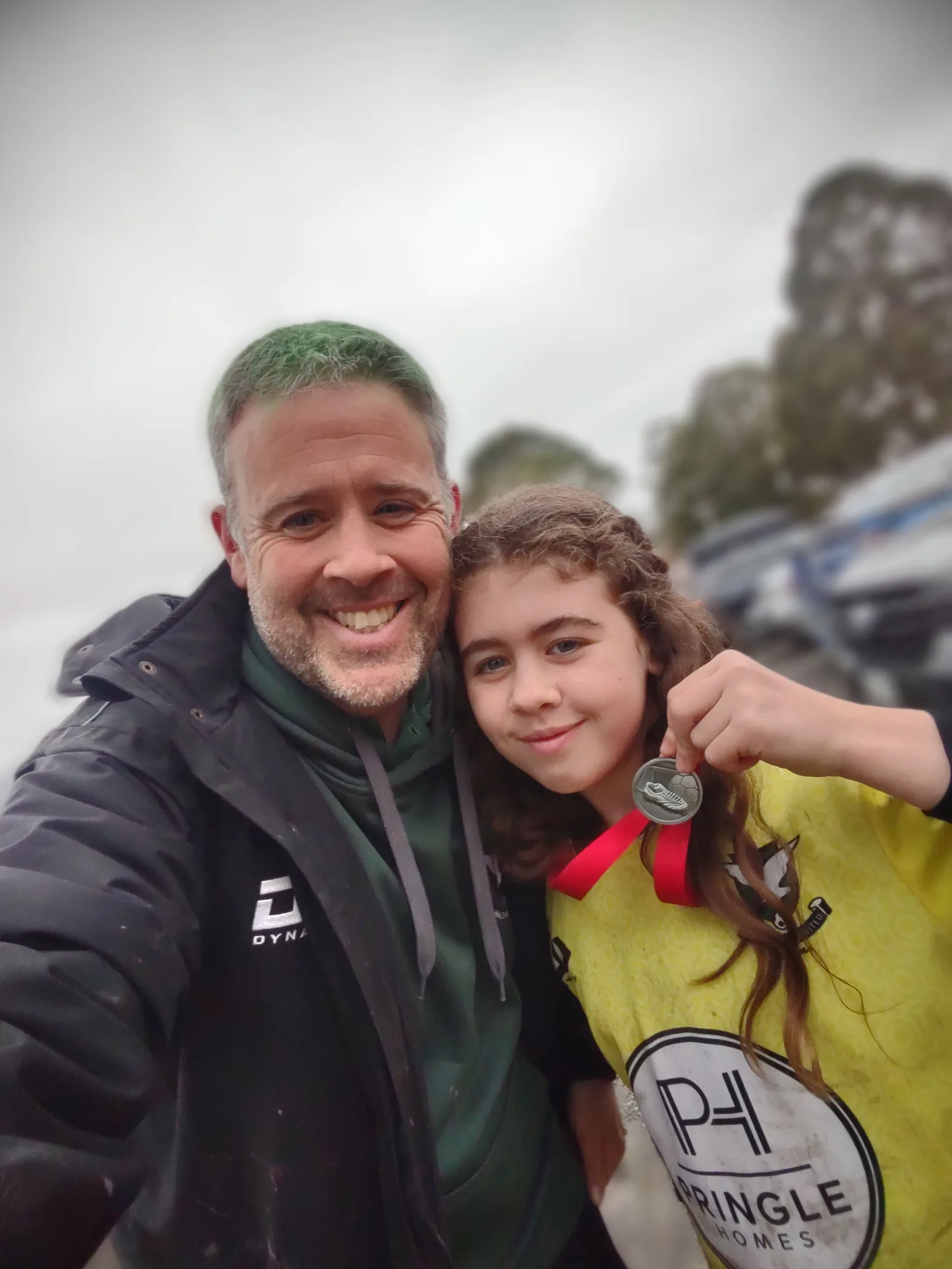 Ian Ebbs with his daughter after a game, both smiling
